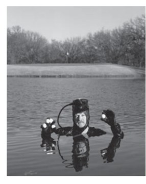 Photograph of a golf-ball diver surfacing in a golf course pond. Credit: Andrew Geiger/Getty Images
